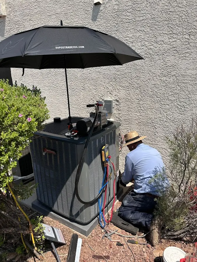 HVAC technician performing outdoor AC maintenance in Newark